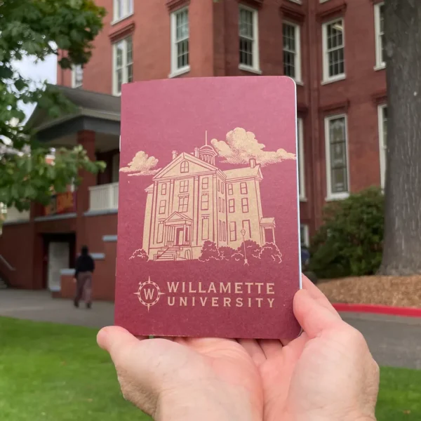 Willamette University Custom Notebook held in front of a university building