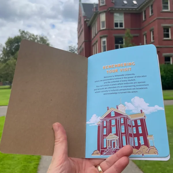 Willamette University Custom Notebook held in front of a university building