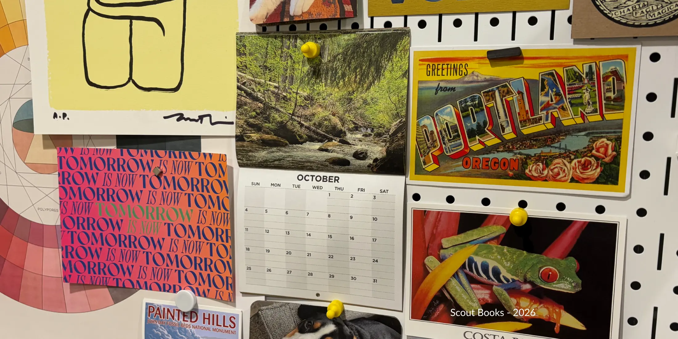 Calendar on a wall with other postcards